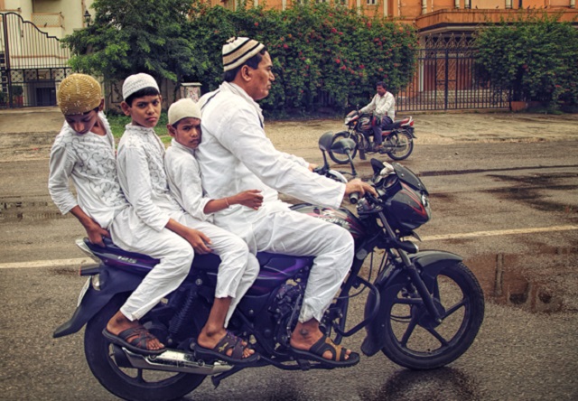 Family on a Motorcycle Dressed for Mosque